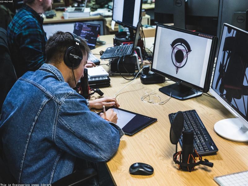 A modern minimalist workspace with high-end equipment, coding environment on screen